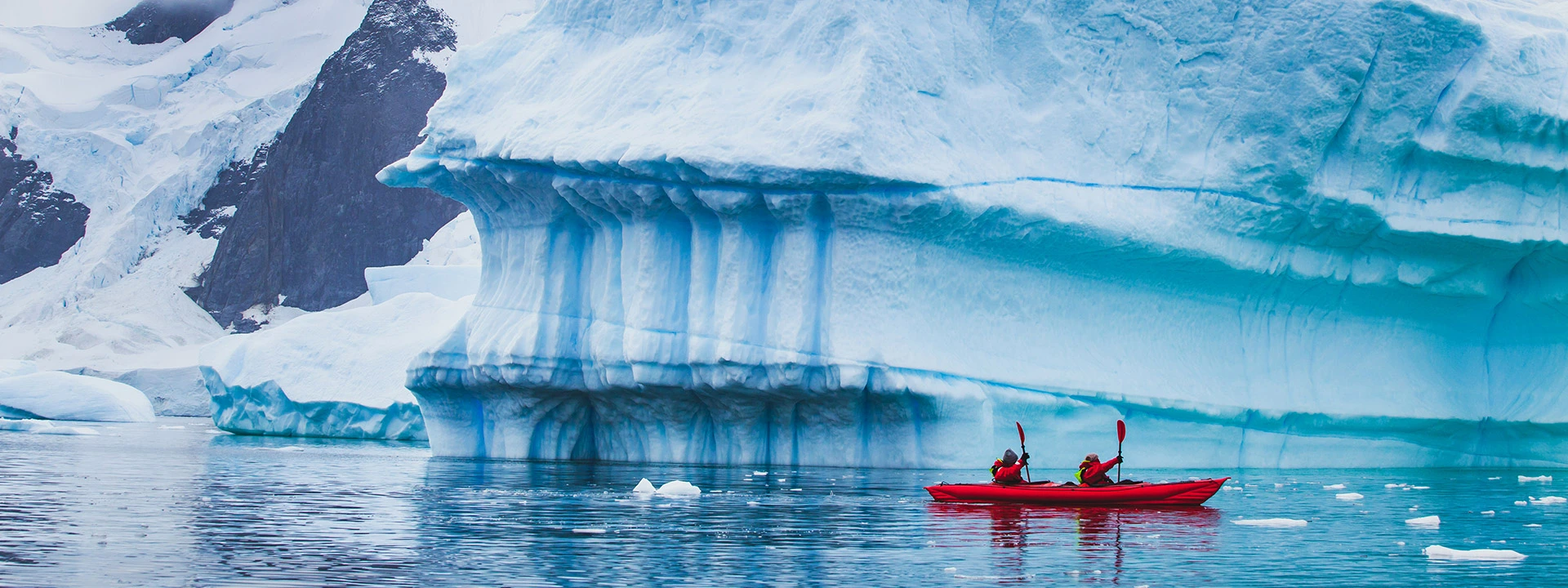 kayaking through the ice fjords on an Antarctica cruise